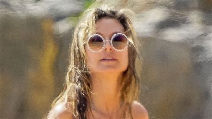 Heidi Klum, 50, goes topless in just thong bikini bottoms as she makes out with husband Tom Kaulitz on St Barts beach