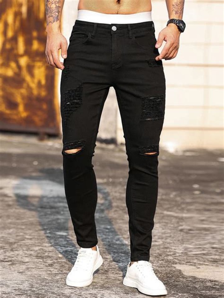 Jinger Duggar is stylish in ripped black jeans as she strikes a pose