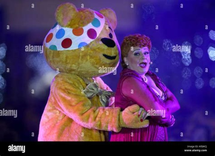 Kylie Minogue beams as she performs at the Covent Garden Christmas lights turn on with Pudsey the Bear