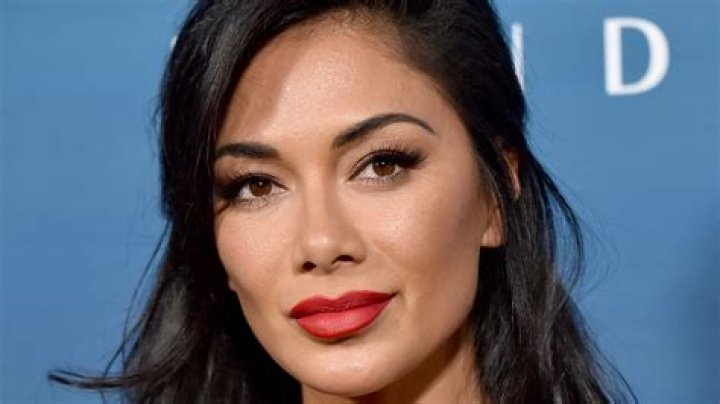 Nicole Scherzinger stuns in cut-out white swimsuit - but fans slam pics as 'insensitive'