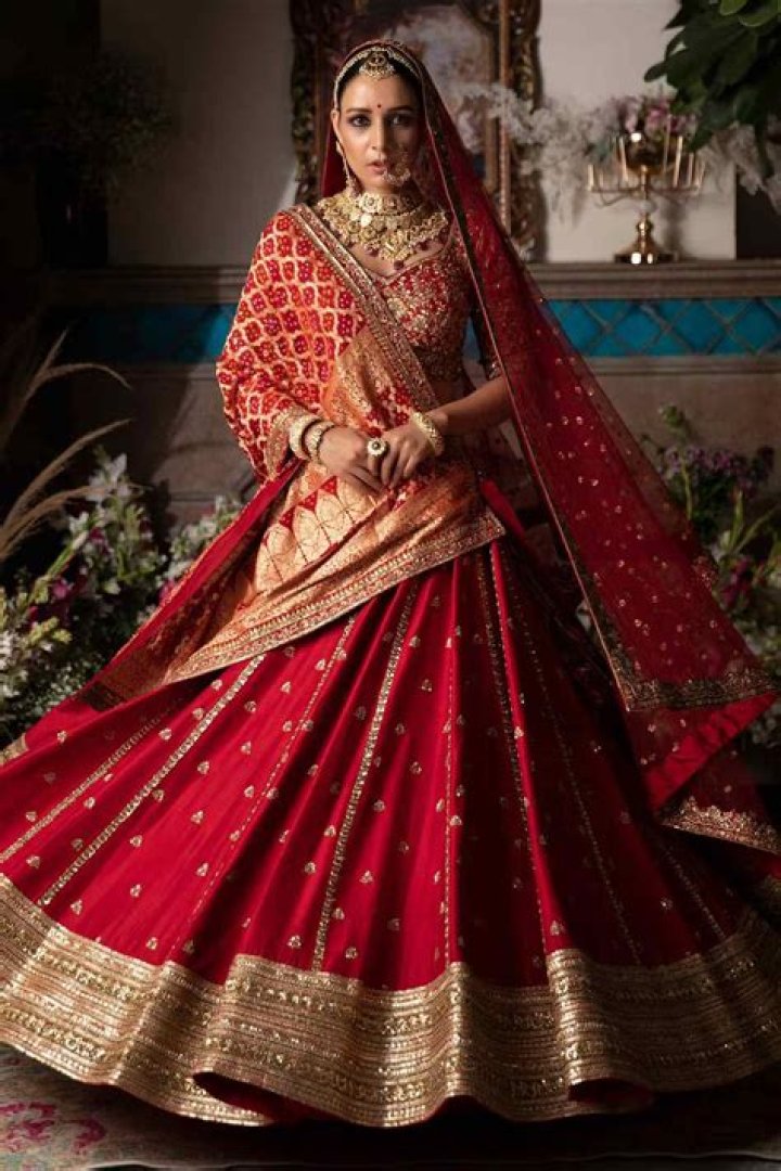 Pooja Hegde is giving us major bridesmaid goals in a red lehenga ensemble; check its mind-blowing price