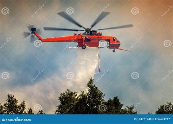 Saddleworth Moor fire -helicopter drops 1,000 litres of water on Aberystwyth wildfire as man is held over 'arson' amid 'blaze Britain' heatwave