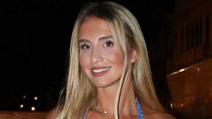 Stunning sports presenter leaves nothing to the imagination as she spills from dress that can barely contain her