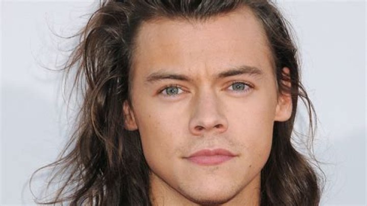 Watch Harry Styles high kick his way to a wardrobe malfunction in metallic jumpsuit